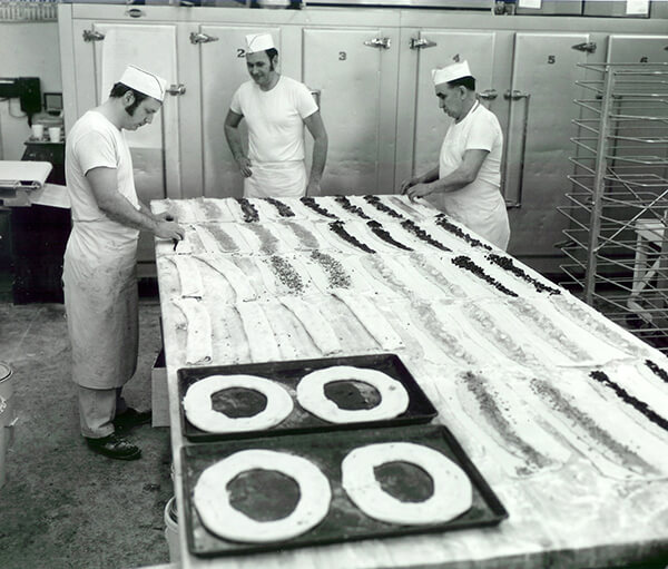 Ray Olesen and with other bakers working in a kitchen