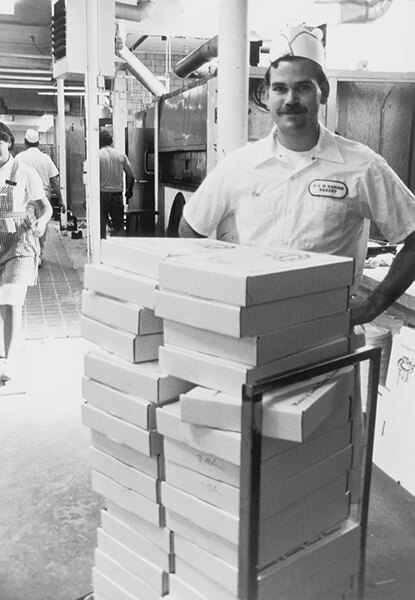 Eric Olesen with a stack of mail order Kringle ready to ship