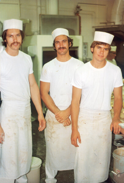 A young Dale, Mike, and Eric Olesen in the bakery