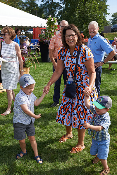 Lisa Olesen dancing with her grandchildren