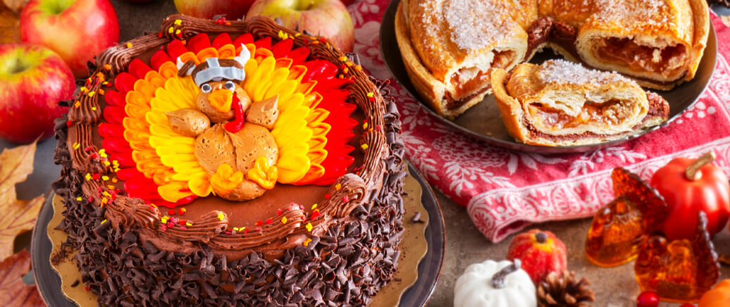 Our delicious Thanksgiving Layer Cake and Apple Cinnamon Kringle Pie on a table spread