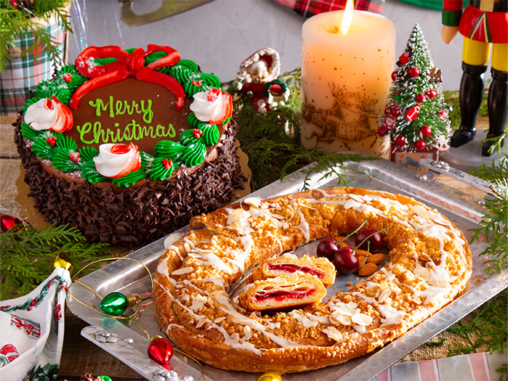 A table spread with the Ohhhh Fudge! Layer Cake and A Very Danish Christmas Kringle