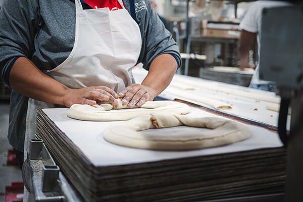 A baker shaping a Kringle