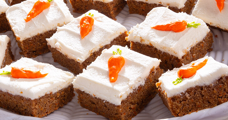 This delectable carrot cake dessert offers a unique twist on traditional flavors, blending the moistness of carrot cake with the rich texture of brownies.