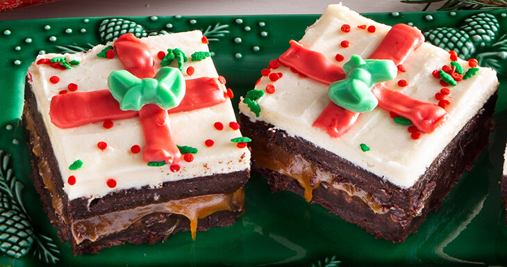 Indulge in our Christmas Present Brownies, featuring delicious triple layers of fudge and caramel, perfect for brownie delivery right to your doorstep this holiday season!