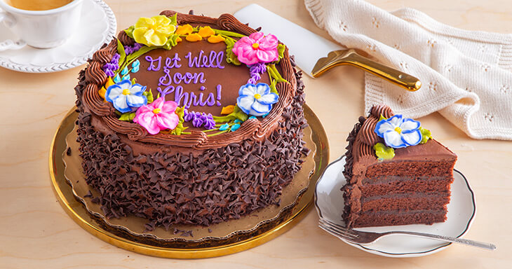 A beautifully crafted cake for a sympathy gift featuring rich Dutch cocoa and buttermilk cake filled with dark chocolate silk, topped with creamy chocolate buttercream and adorned with chocolate curls and a custom message.