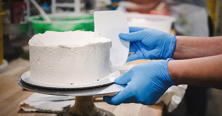 A delicious layer cake with rich buttercream frosting, prepared for cake delivery to your doorstep.