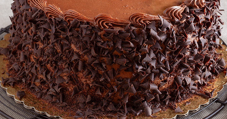 Delicious chocolate cake at the Danish bakery, complete with chocolate curls and a buttercream decoration. Online orders available for delivery!