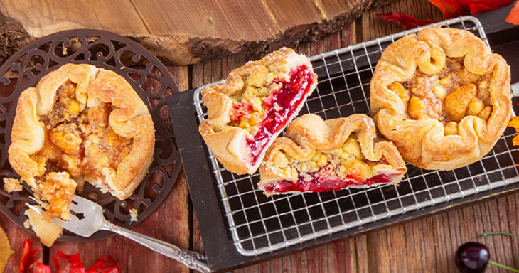 Artisan pies made with fresh Door County cherries and sweet cinnamon apple filling, handcrafted like a traditional French Galette, showcasing quality ingredients for a delicious dessert experience.