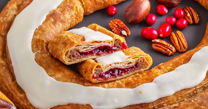 Easy Thanksgiving dessert, Kringle stuffed with extra filling, packed with cranberries and pecans. Perfect centerpiece for Thanksgiving!