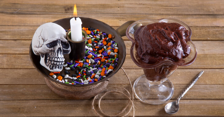 Chocolate filling surrounded by colorful Halloween-themed sprinkles, showcasing a deliciously spooky treat for Halloween.