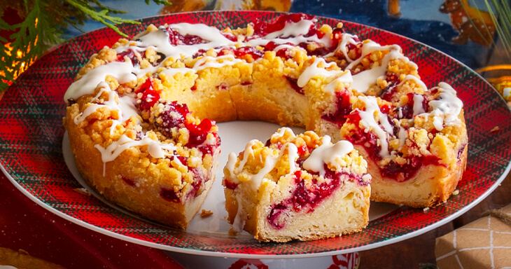 Discover the ultimate coffee cake recipe featuring a delightful blend of Wisconsin cherries and cranberries topped with a creamy icing and crumbly streusel.